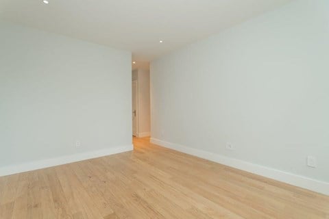 a living room with a wood floor and white walls